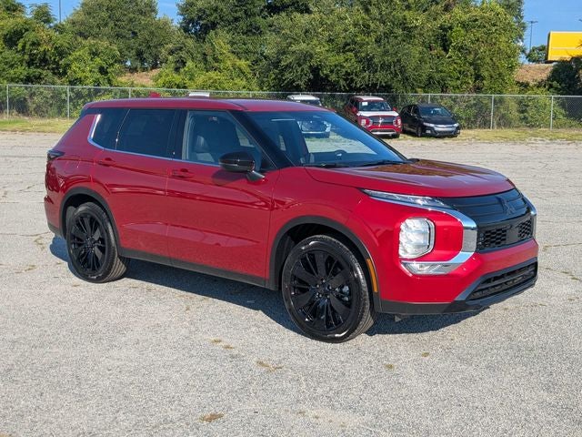 2026 Mitsubishi Outlander LE in Red Diamond — front three-quarter view